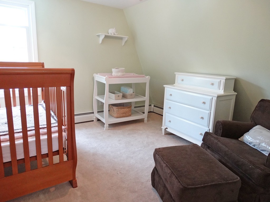 3 Bassett Street Rochester, MA 02770 - Photo 16 of 28 a living room with furniture and a baby crib