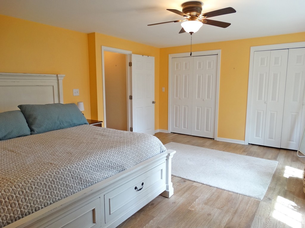 3 Bassett Street Rochester, MA 02770 - Photo 19 of 28 a bedroom with a bed and a chandelier