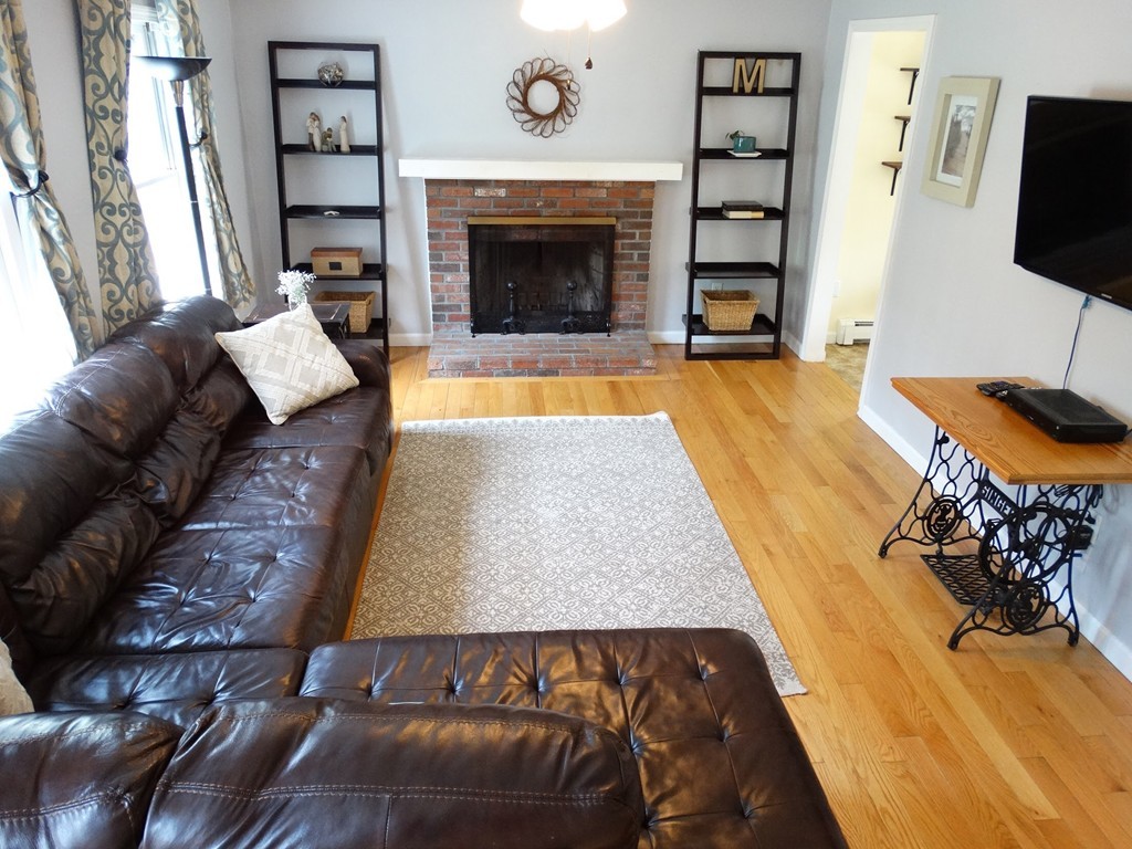 3 Bassett Street Rochester, MA 02770 - Photo 4 of 28 a living room with furniture and a fireplace