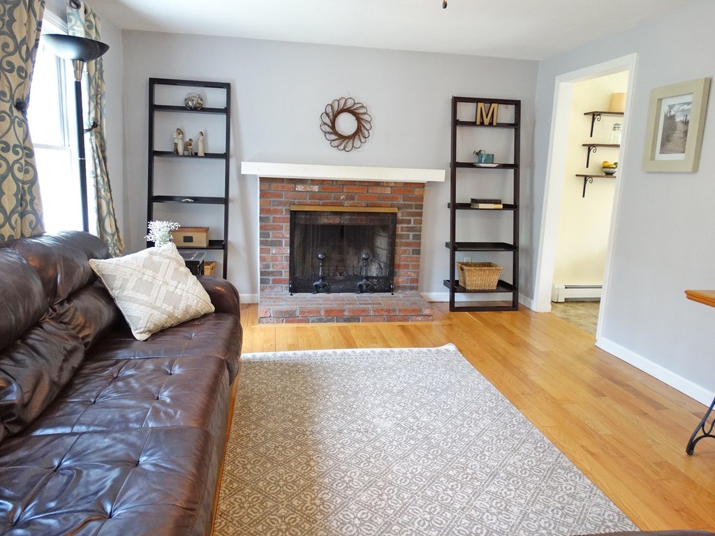 3 Bassett Street Rochester, MA 02770 - Photo 6 of 28 a living room with furniture and a fireplace
