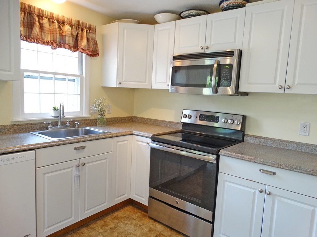 3 Bassett Street Rochester, MA 02770 - Photo 8 of 28 a kitchen with white cabinets stainless steel appliances and sink