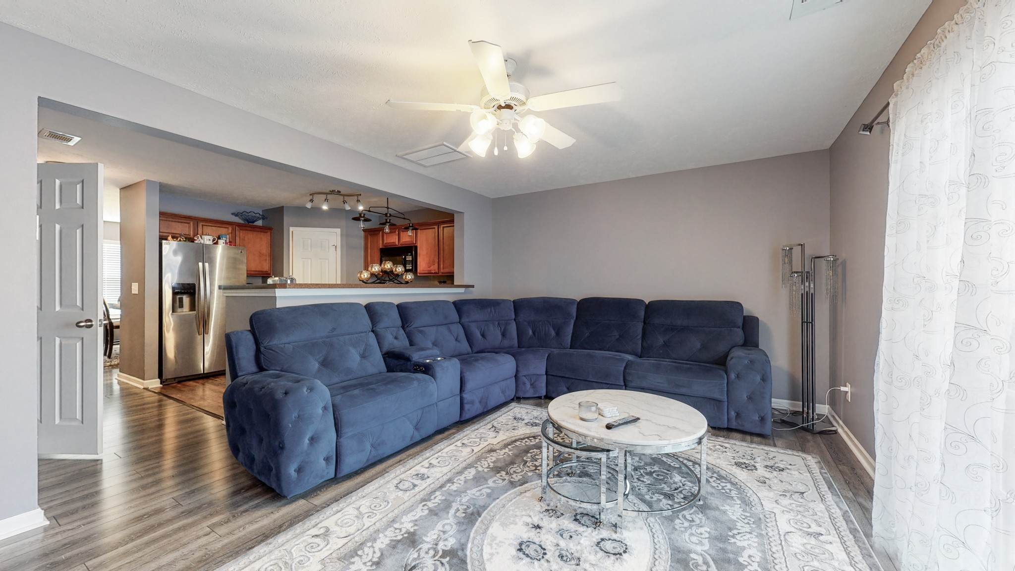 a living room with a couch and a chandelier