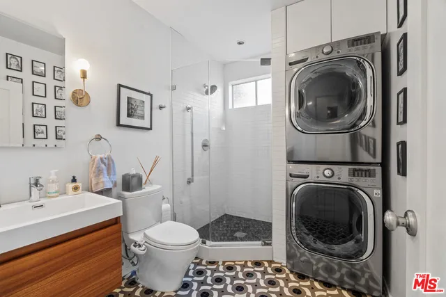 a bathroom with a washing machine and a sink
