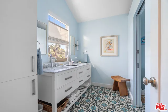 a bathroom with a sink a toilet and a window