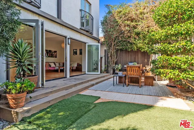a view of a chair and tables in the backyard of the house