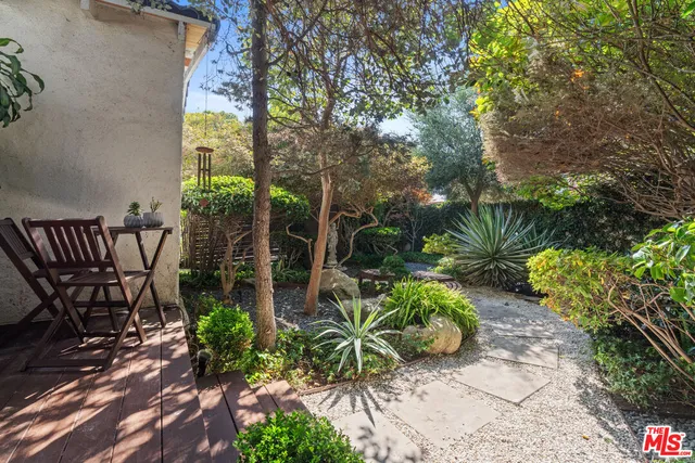 a bedroom with a bed table and window