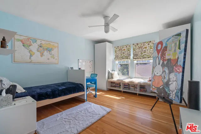 a view of a chairs and table in the back yard of the house