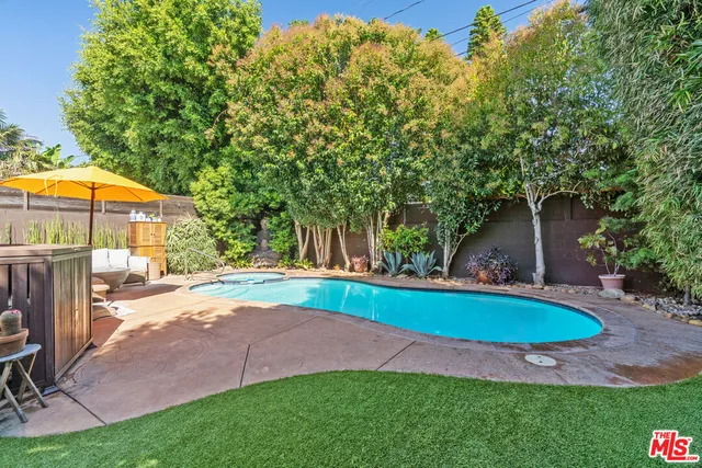 a view of swimming pool with a yard and sitting area