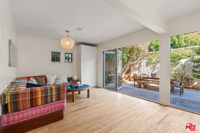 a bedroom with furniture and a large window