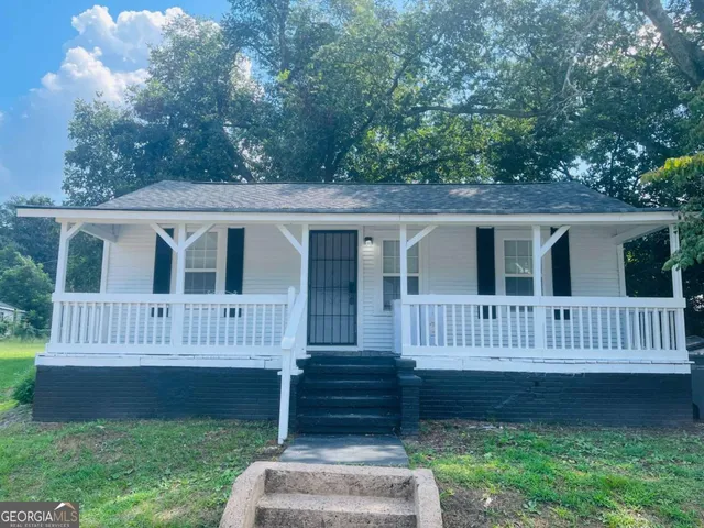 a view of a house with a yard and deck