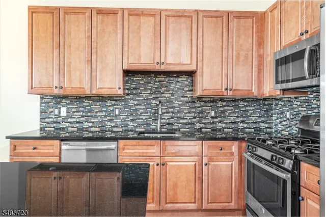 a bathroom with a granite countertop sink mirror vanity and a bathtub