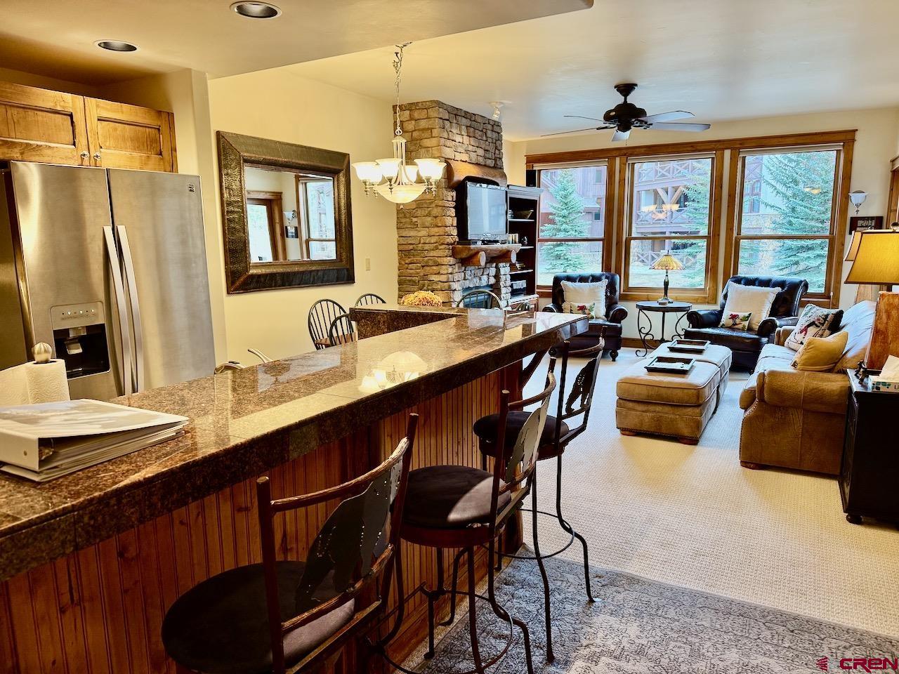 9 Hunter Hill Road, Unit 205 Crested Butte, CO 81225 - Photo 5 of 28 a very nice looking living room with a large window and stainless steel appliances