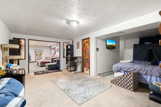 a bedroom with furniture and a flat screen tv