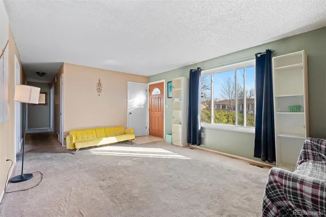 a spacious bedroom with a bed and a window