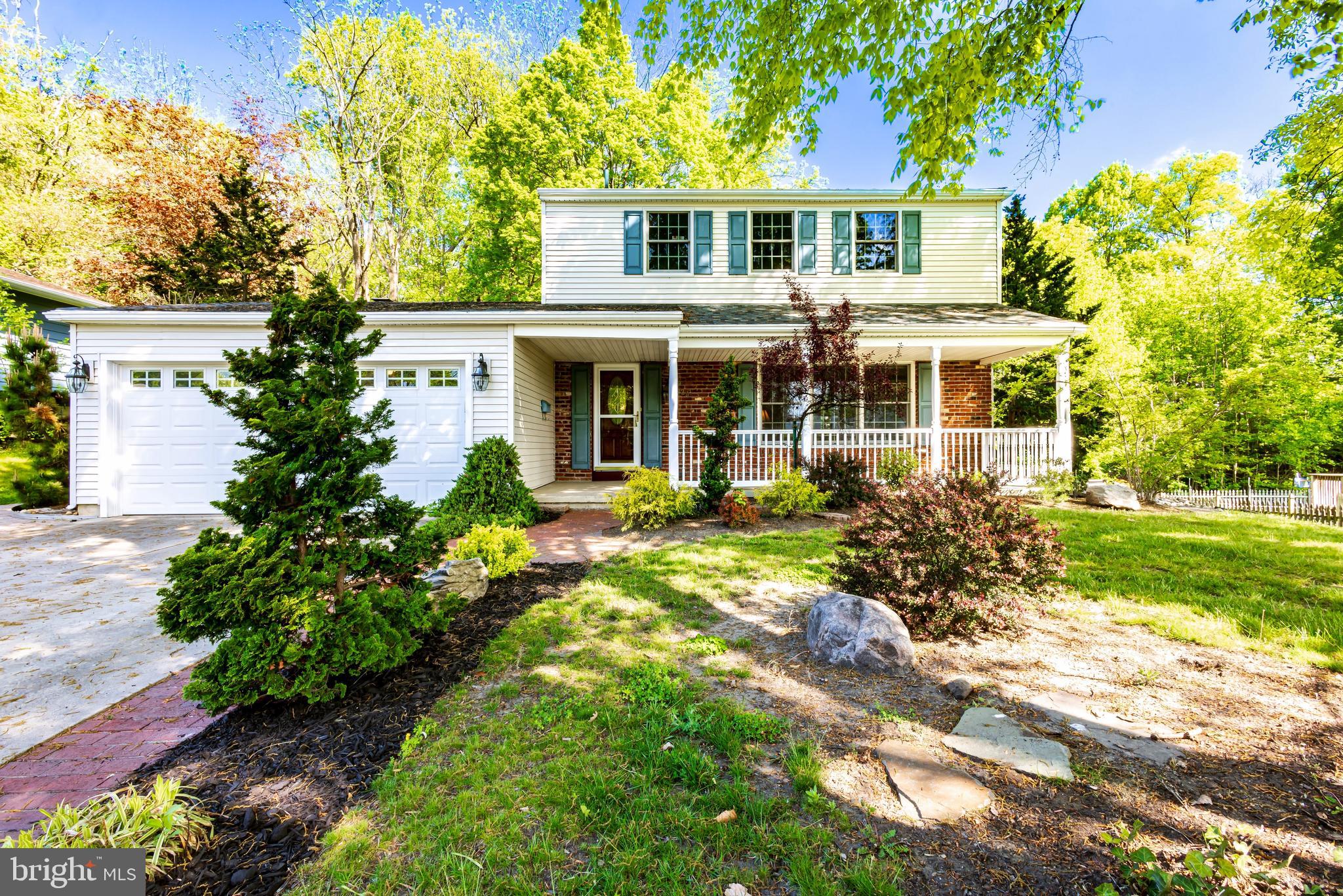 a front view of a house with a yard and potted plants