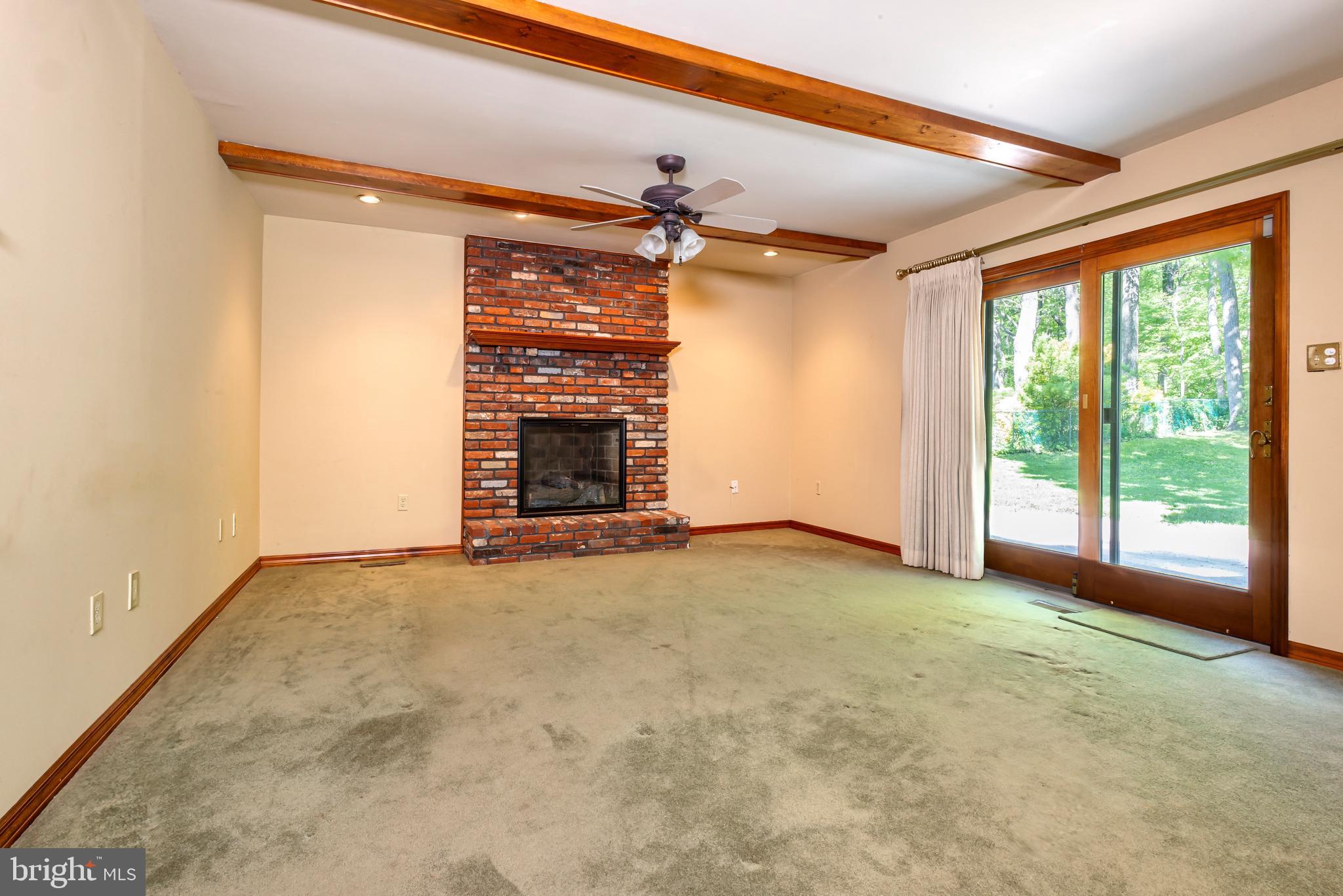 24 Cedar Creek Drive Clementon, NJ 08021 - Photo 5 of 28 an empty room with windows fireplace and a ceiling fan