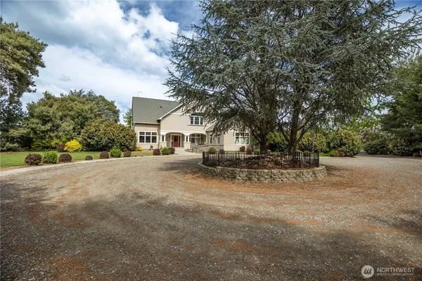a view of a house with a large tree