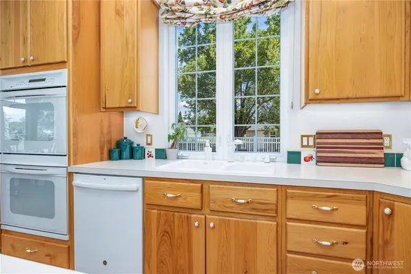 a kitchen with granite countertop cabinets and window