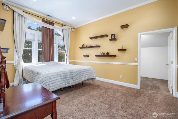 a spacious bedroom with a bed and a dresser