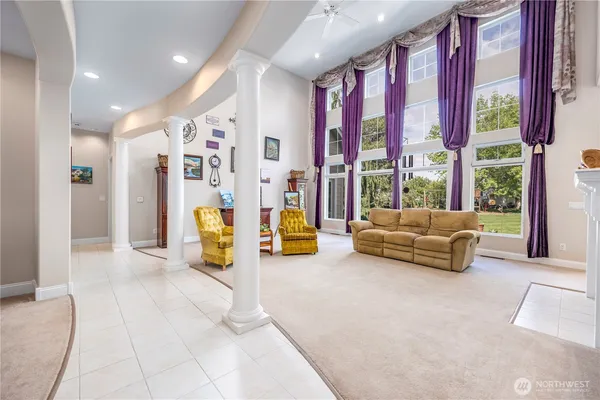 a living room with furniture and large windows