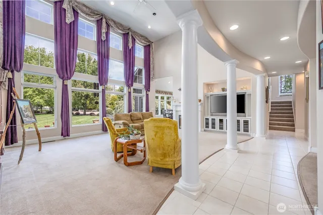 a lobby with furniture and floor to ceiling window