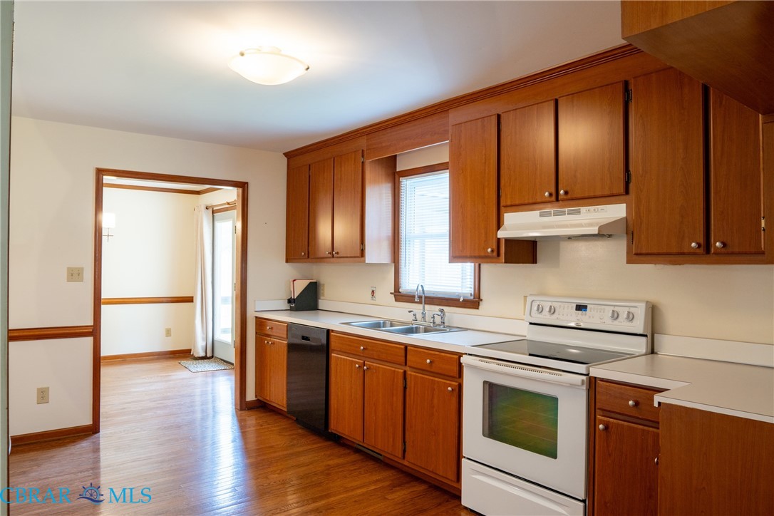2847 Decatur Drive Hayes, VA 23072 - Photo 13 of 30 Kitchen featuring electric stove, wood finish cabinetry, light countertops, and dishwasher