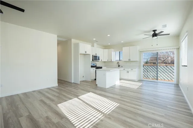 a view of a kitchen with wooden floor and a sink