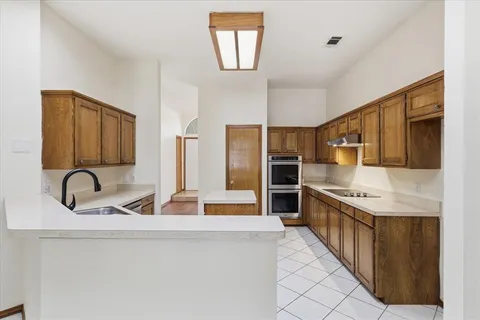 a kitchen with a sink and cabinets