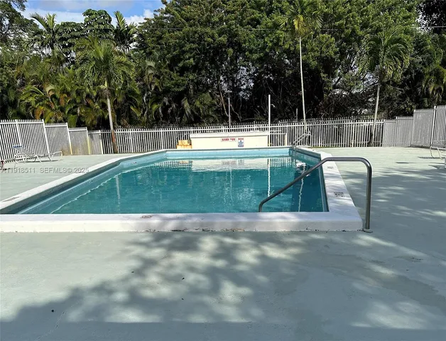 a view of a swimming pool with a backyard