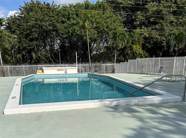 a view of a swimming pool with a yard