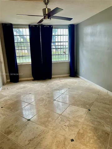 a view of an empty room with a window