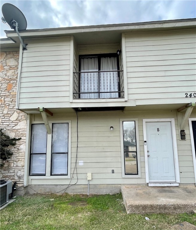 2406 Toro Lane, Unit B Bryan, TX 77807 - Photo 2 of 13 a front view of a house with a yard