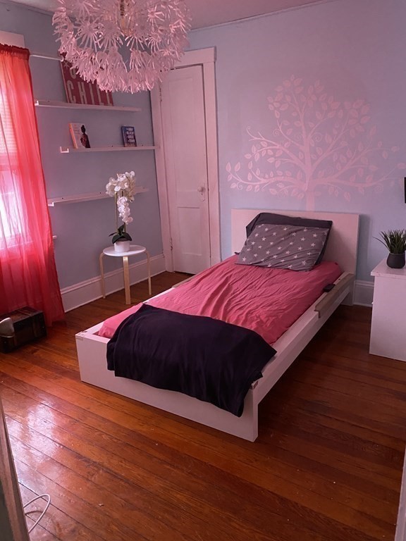 282 Commonwealth Avenue Springfield, MA 01108 - Photo 14 of 19 a bedroom with a bed and wooden floor