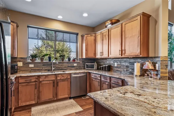 a kitchen with a sink stove and cabinets