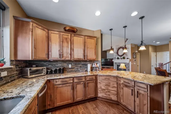 a kitchen with stainless steel appliances granite countertop a sink stove and cabinets