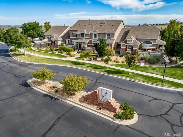 an aerial view of a house with a yard basket ball court and a fountain