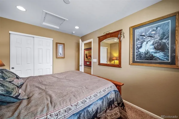 a bedroom with a bed and a painting on the wall