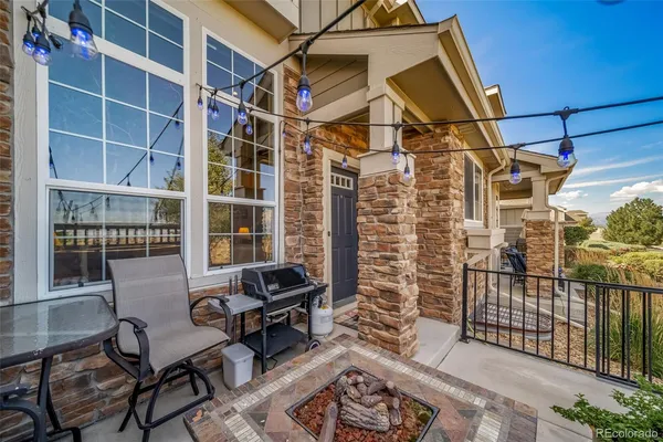 a backyard of a house with table and chairs