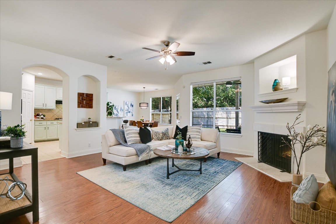 a living room with furniture fireplace and window