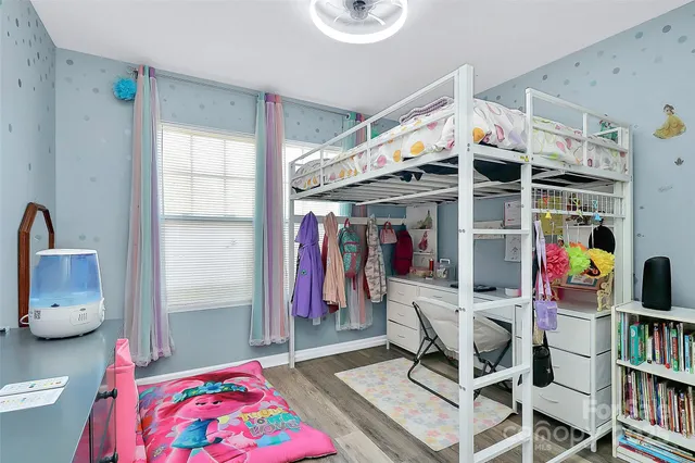 a living room with furniture and a book shelf