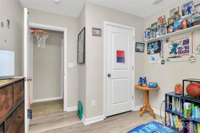 a living room with furniture and a book shelf