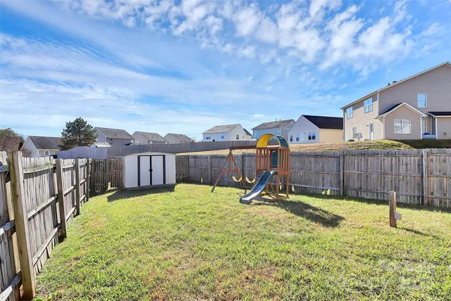 a view of a house with backyard and a slide