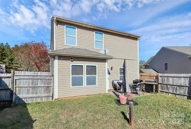 a view of a dinning table and chairs in back of a house