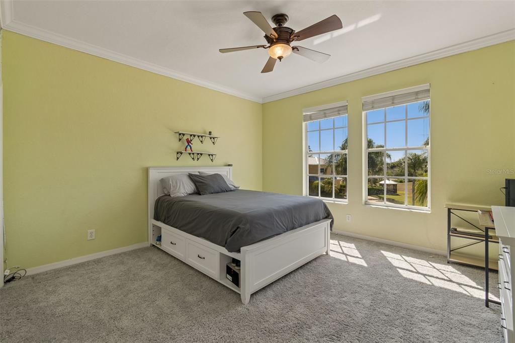 703 Bunker View Drive Apollo Beach, FL 33572 - Photo 24 of 49 a spacious bedroom with a bed and a window