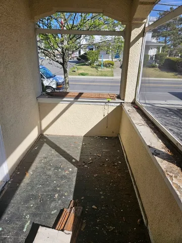 a view of a porch with furniture and a yard