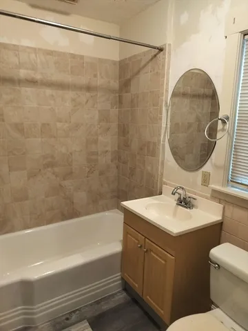 a view of a balcony with floor to ceiling windows with wooden floor