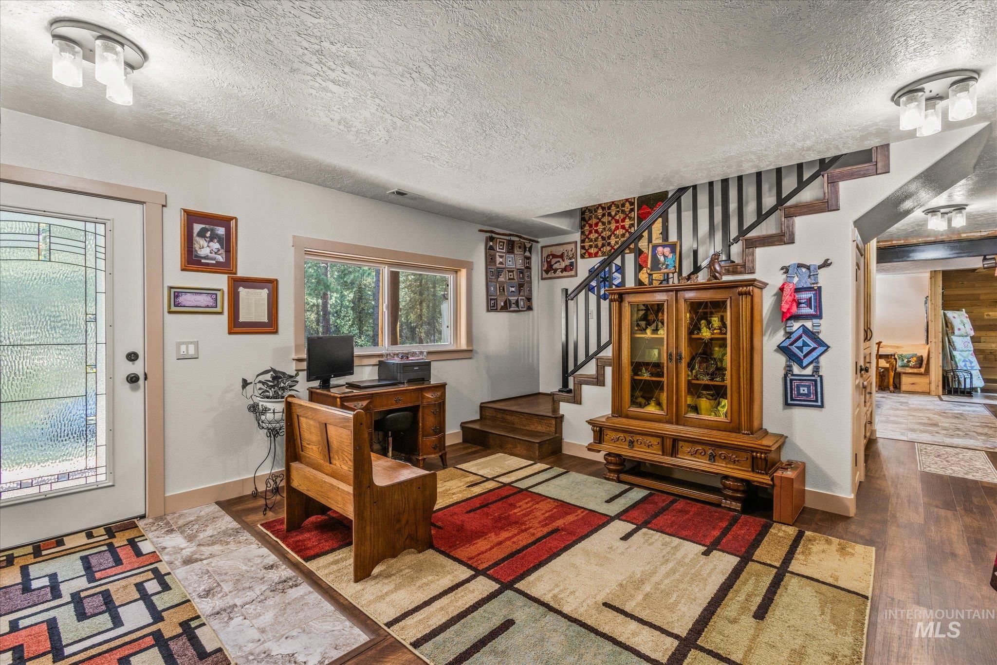 1 Sunset Trail Banks, ID 83602 - Photo 17 of 42 Entryway featuring wood-finish flooring, a decorative glass paneled door, and a built-in staircase with dark railings