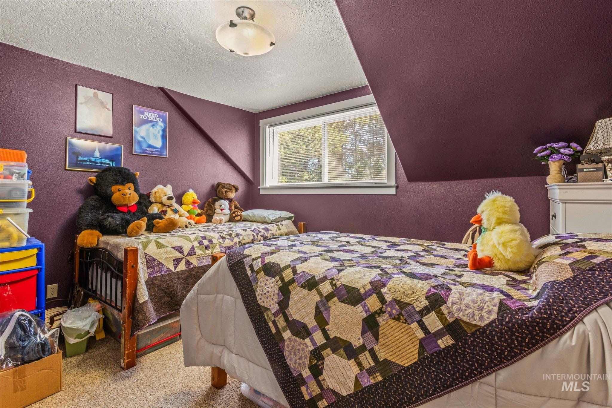 1 Sunset Trail Banks, ID 83602 - Photo 29 of 42 Bedroom with rich plum-colored walls and sloped ceilings