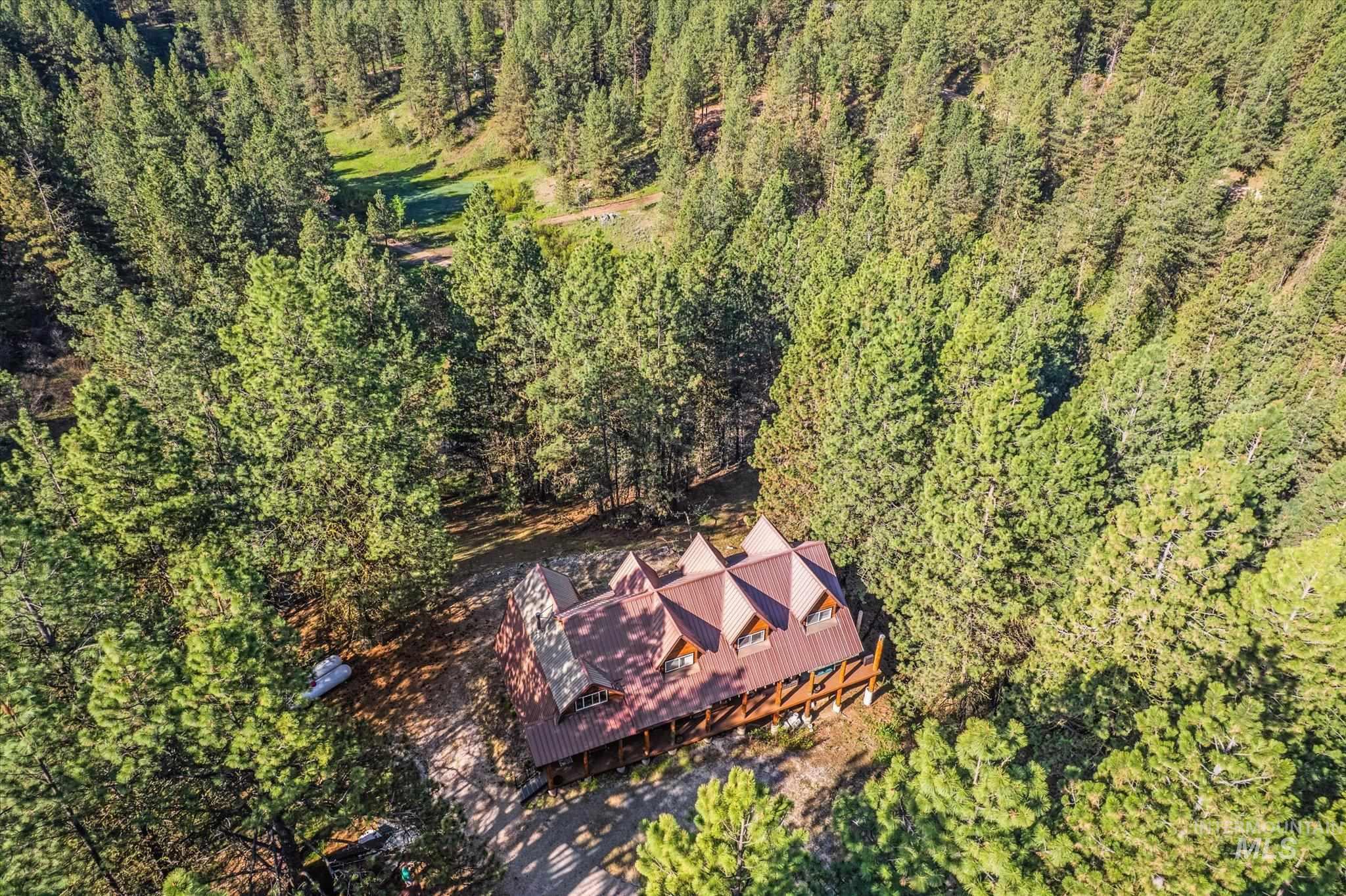 1 Sunset Trail Banks, ID 83602 - Photo 36 of 42 Expansive treed acreage with a lodge-style residence featuring a multi-gabled roofline and a wrap-around porch