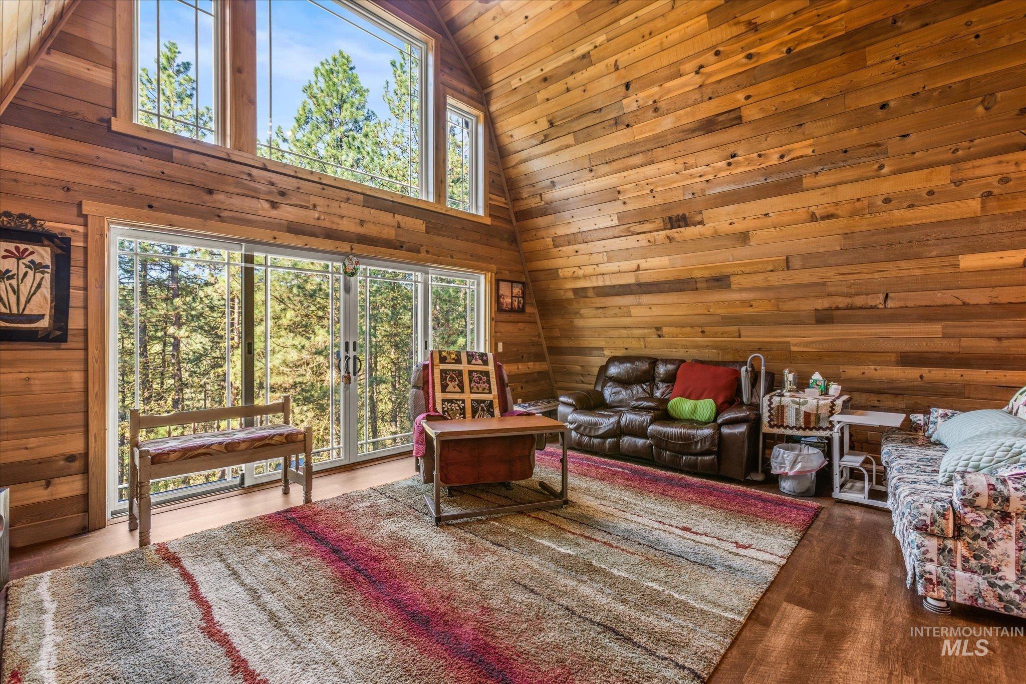 1 Sunset Trail Banks, ID 83602 - Photo 4 of 42 Vaulted ceiling living space featuring extensive wood paneling